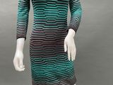a mannequin wearing a green and black striped dress