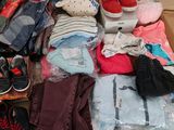 a pile of clothes and shoes on the floor