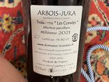 a bottle of wine that is sitting on a rug