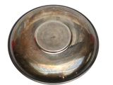 a silver bowl on a white background with a red spot