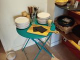 a table with plates and bowls on it in a kitchen