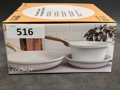packaging of a set of two white bowls and a saucer with a wooden handle