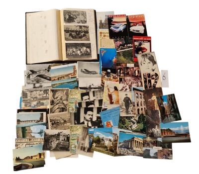 a pile of old photographs and postcards on a white surface