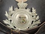 a close up of a hat with a medal on it
