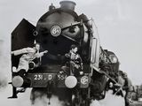 a black and white photo of a train with people on it
