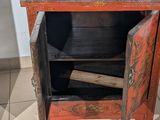 a small cabinet with a baseball bat inside of it