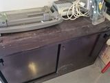 a tv sitting on top of a table with a lot of wires