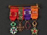 a close up of a group of medals on a black surface