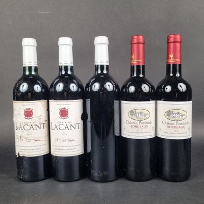 six bottles of wine are lined up in a row on a table