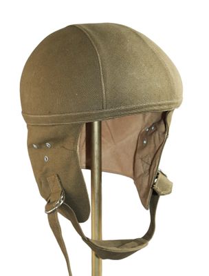 brown leather helmet on a stand on a white background