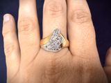 a woman ' s hand with a diamond ring on it