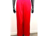 Le mannequin porte un pantalon rouge et un haut noir.