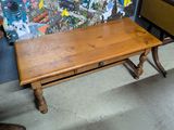a small wooden table with a drawer underneath it