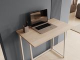 a laptop computer sitting on a wooden desk in a room