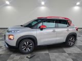 a silver and red citrole is parked in a room