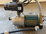 a pump that is sitting on the floor next to a hose