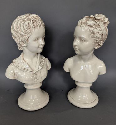 pair of white porcelain busts of a boy and a girl