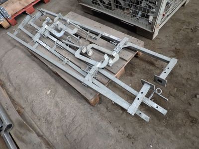several pieces of metal are laying on the ground next to a pallet