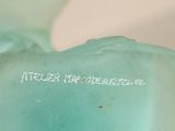 a blue vase with writing on it sitting on a table