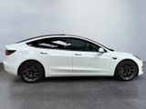 the tesla model s is parked in a showroom with a white wall