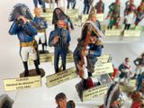 many figurines of soldiers on display in a display case