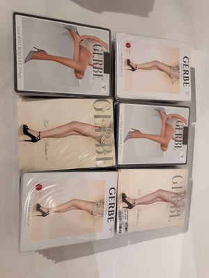four pairs of women ' s tight stockings are on display in a display case