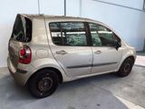 a small silver car that is parked in a garage