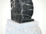 black and white marble sculpture of a bird on a rock