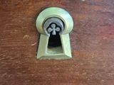 a wooden cabinet with a keyhole in it