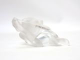 a clear object with a tag on it sitting on a white surface