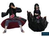 anime figurines of a man sitting on a rock with a sword in his hand