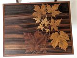 a picture of a picture of leaves on a wooden board