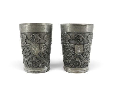 two cups that are sitting side by side on a white surface