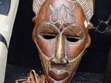 a wooden mask that is sitting on a table