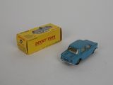 a blue toy car next to a yellow box on a white surface