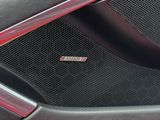 a close up of a car ' s grille with a car number plate on it