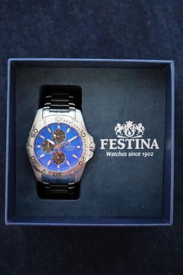 blue and black watch in a blue box with a logo on it