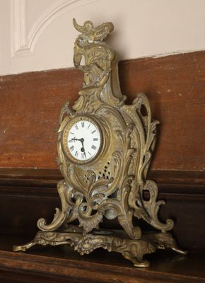 a clock on a shelf in the corner of a room