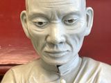 a white statue of a man with a hand on his chin