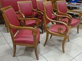 six red chairs sitting in a room with a white tile floor