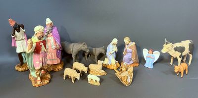 many figurines of people and animals on a table