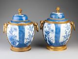 pair of blue and white vases with gilded handles and handles