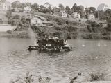 black and white photo of a small boat on a river
