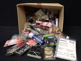 a cardboard box filled with various items on a black surface