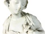 a statue of a woman with a flower in her hand