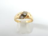 a close up of a gold ring with two diamonds on it