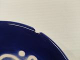 a close up of a blue plate with a clock on it