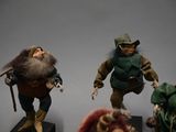 three figurines of a man and a woman dressed as gnomes