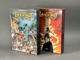 the two books are sitting side by side on a gray surface