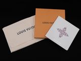 three louis vuitto cards in a box on a black background